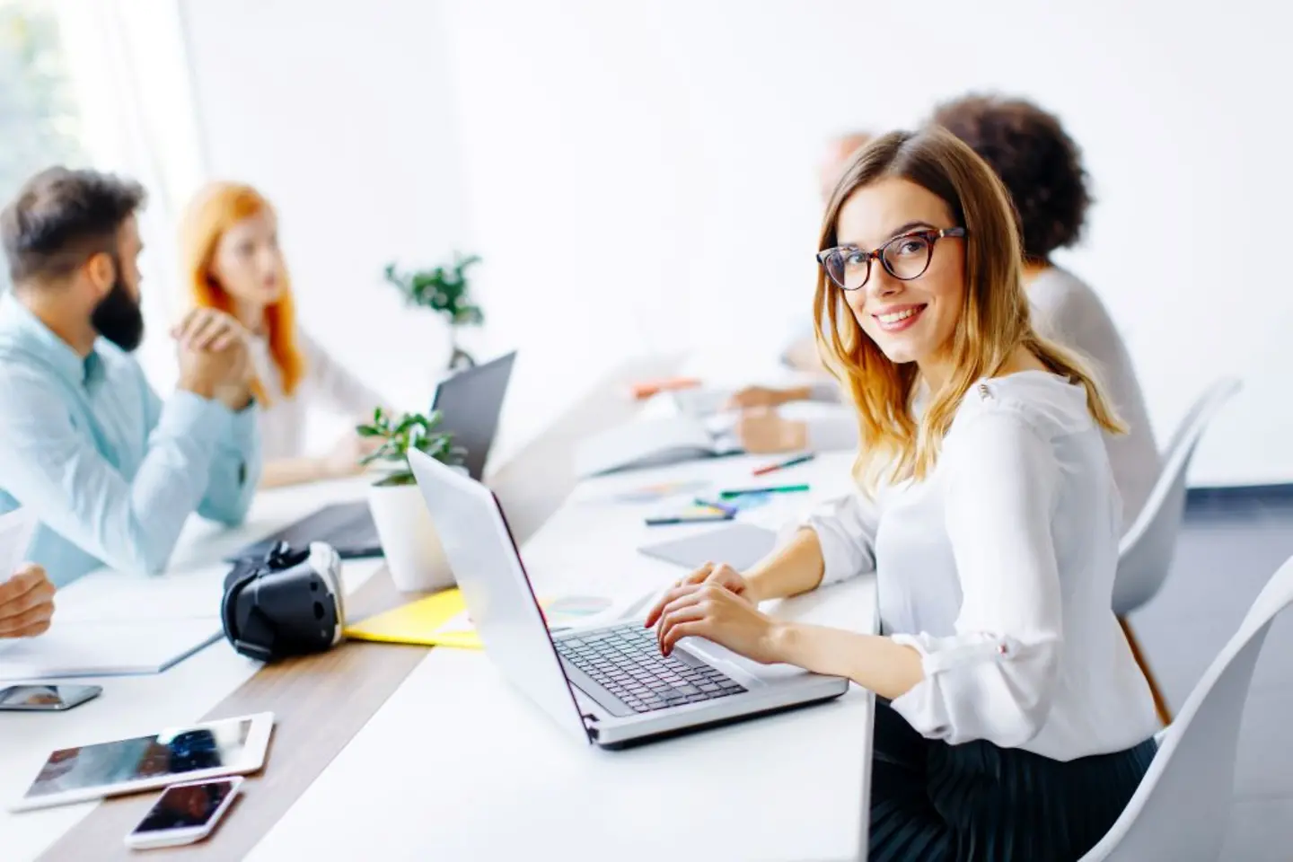 Smiling female T-Systems representative with a laptop