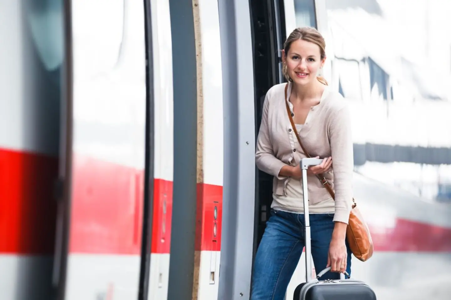 Women with her luggage boarding a Deutsche Bahn train