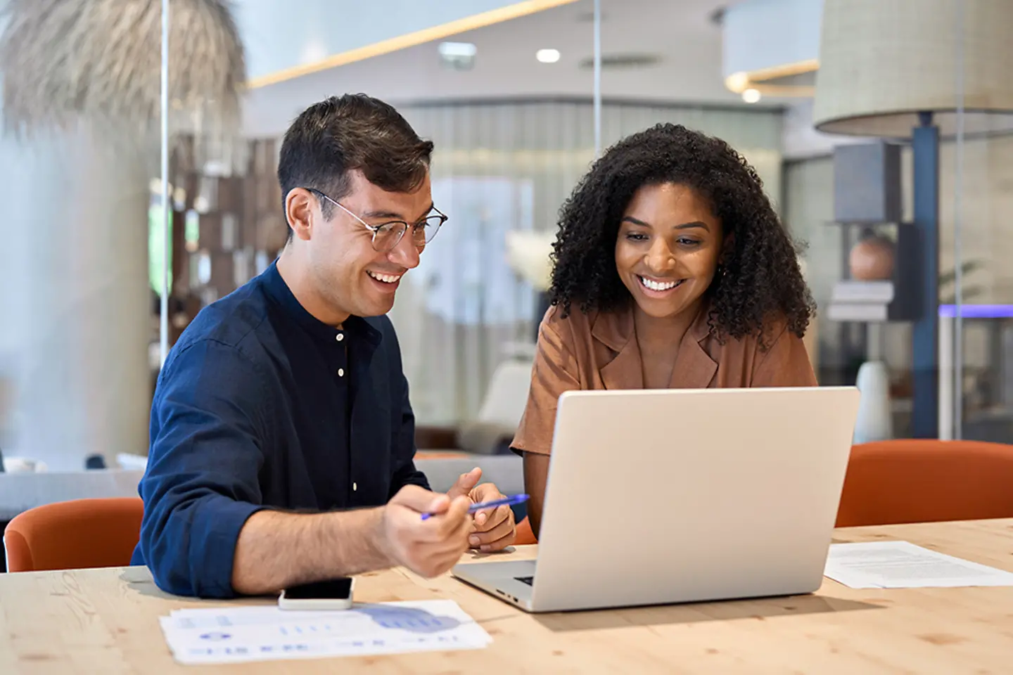 Two coworkers participating in an online learning session