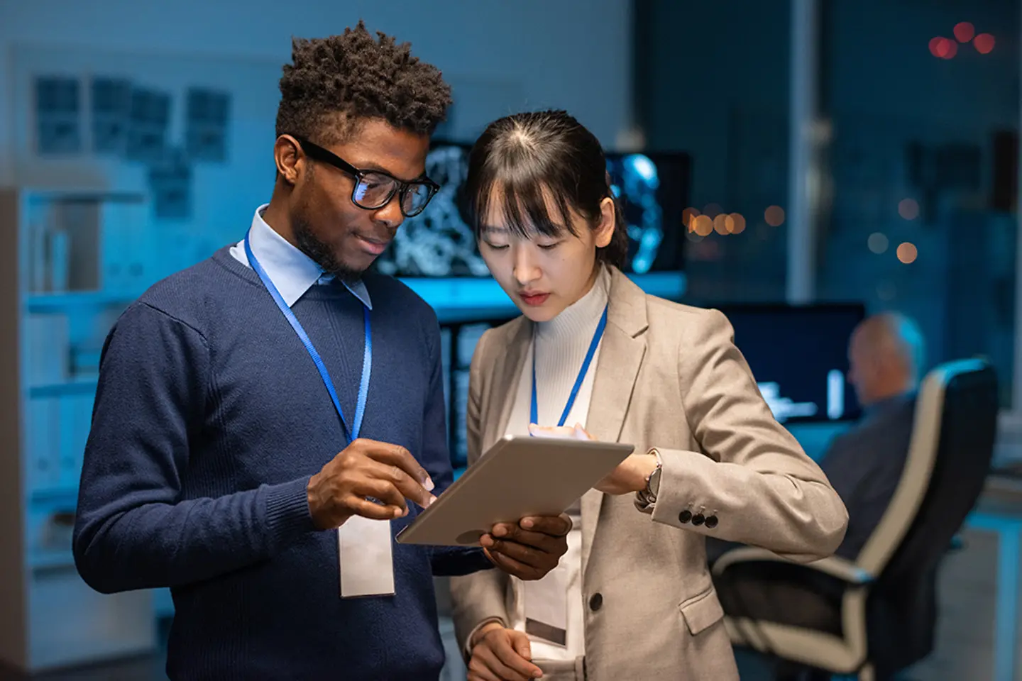 Colleagues checking data on tablet