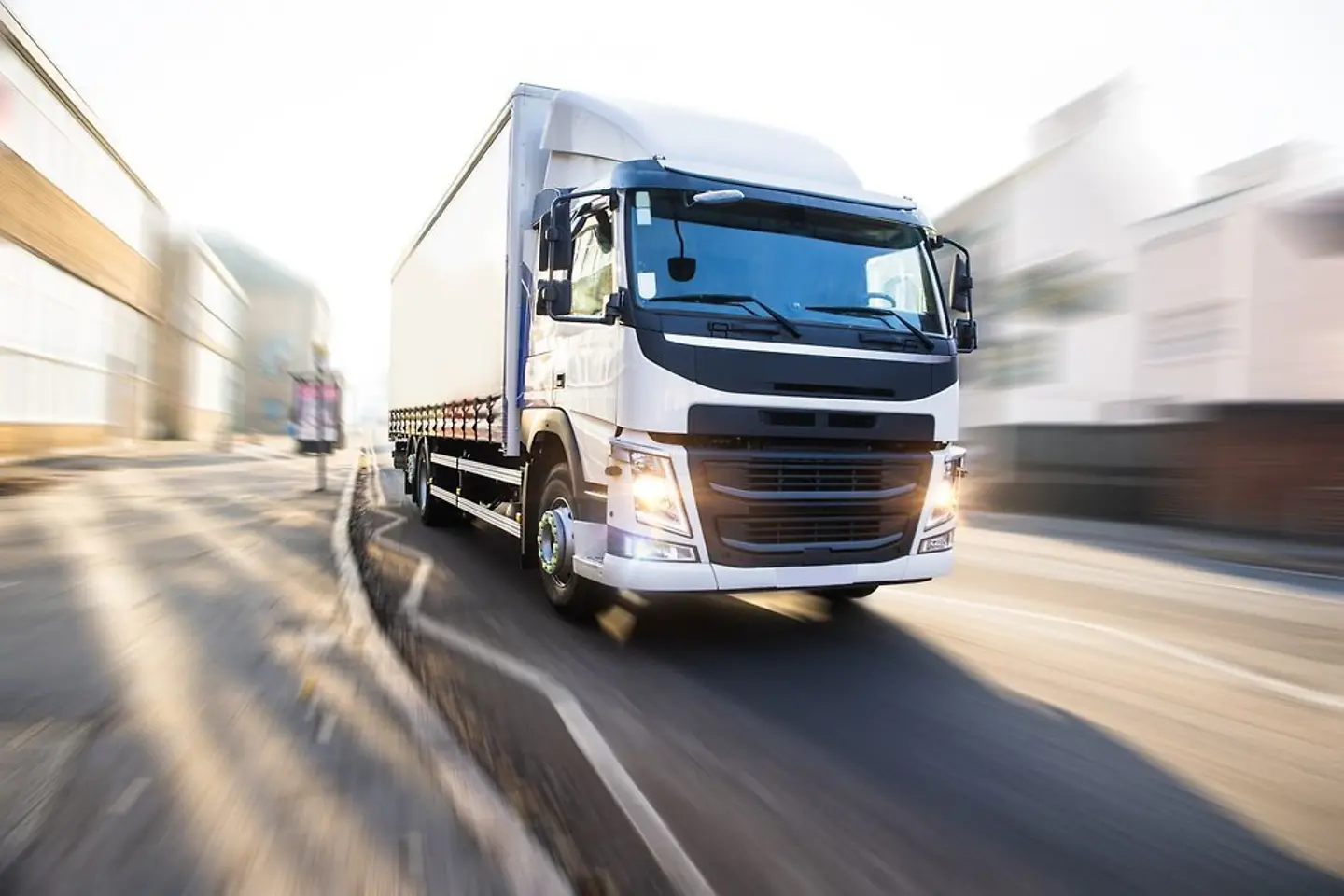 White truck crossing a town