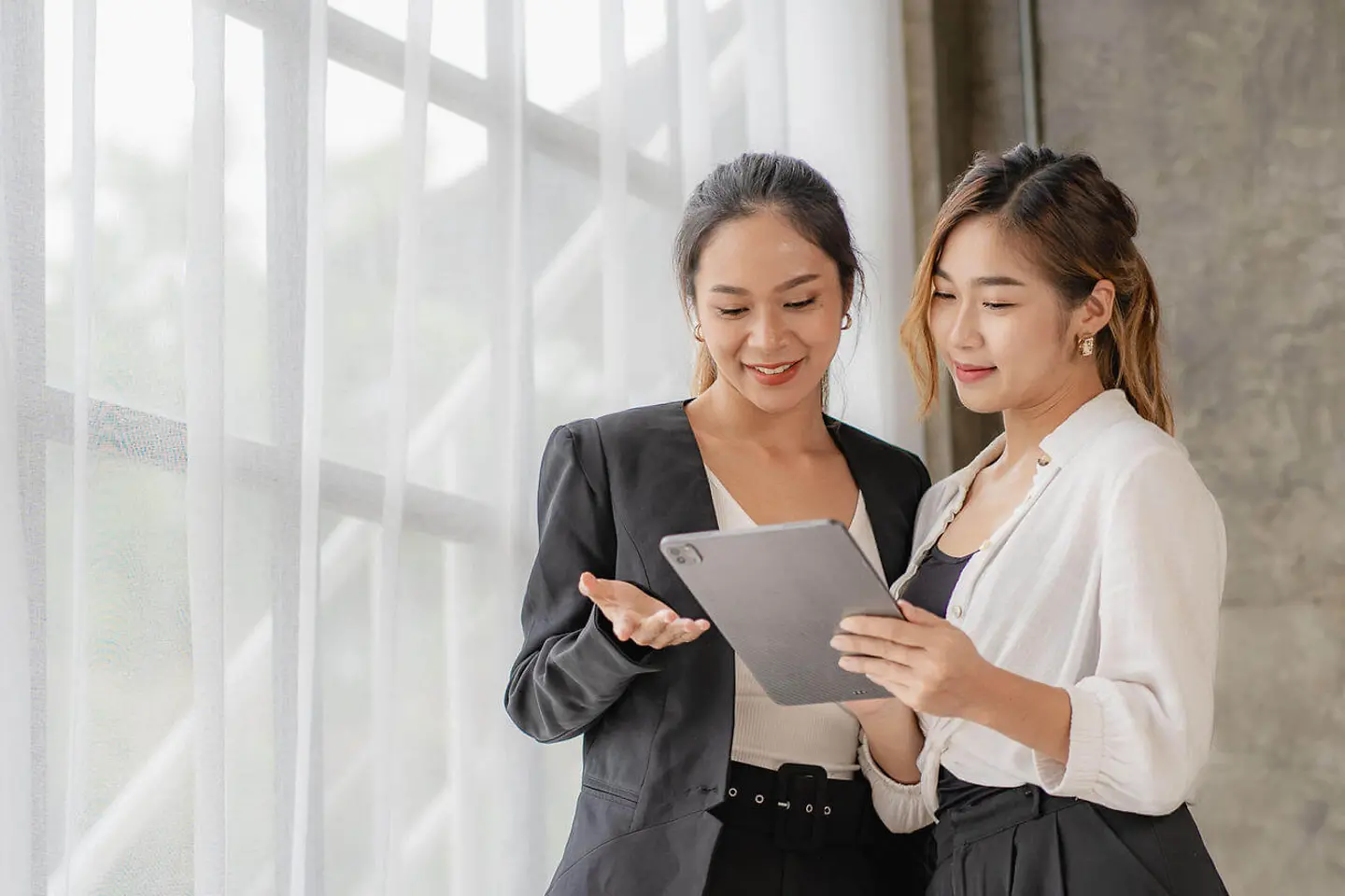 Two women looking at tablet