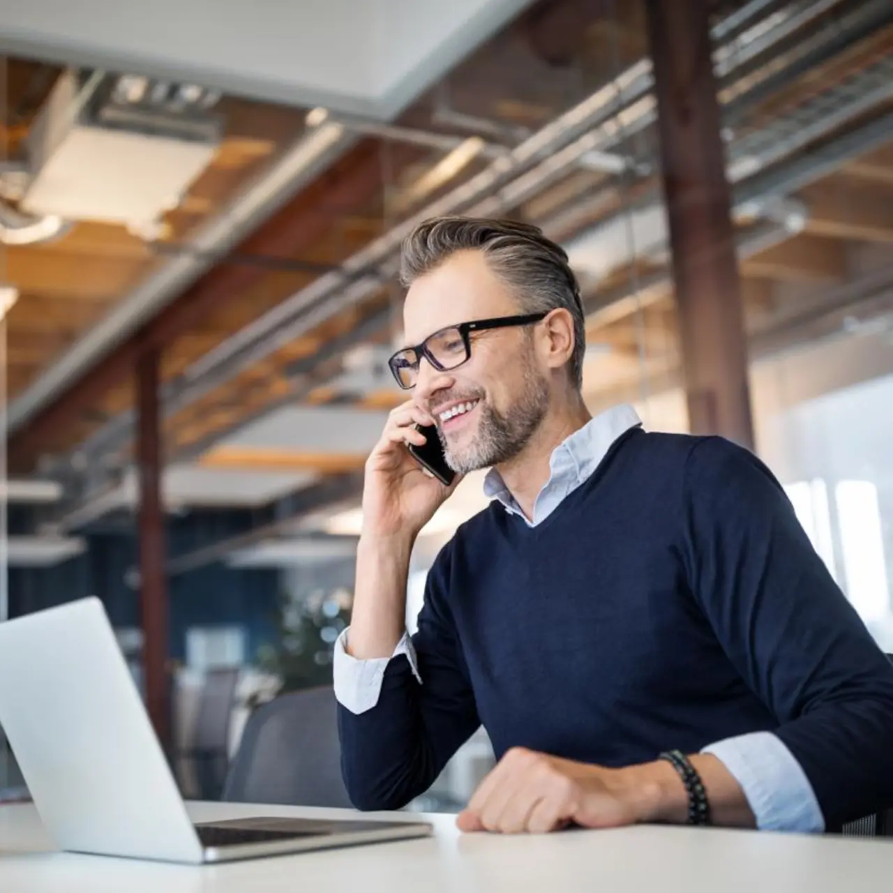 Businessman on the phone at his laptop