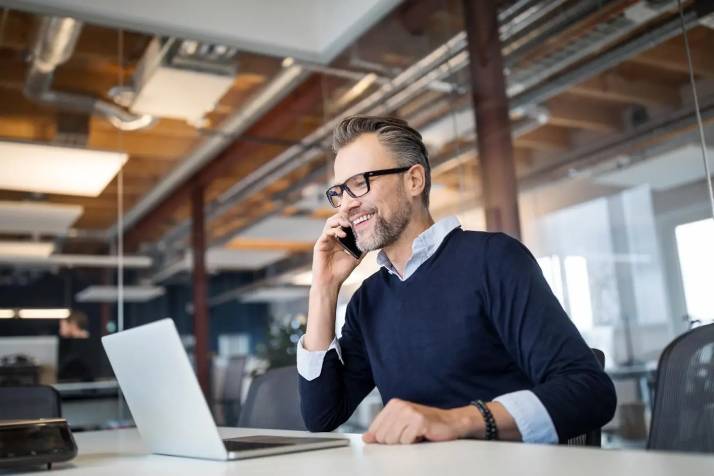 Businessman on the phone at his laptop